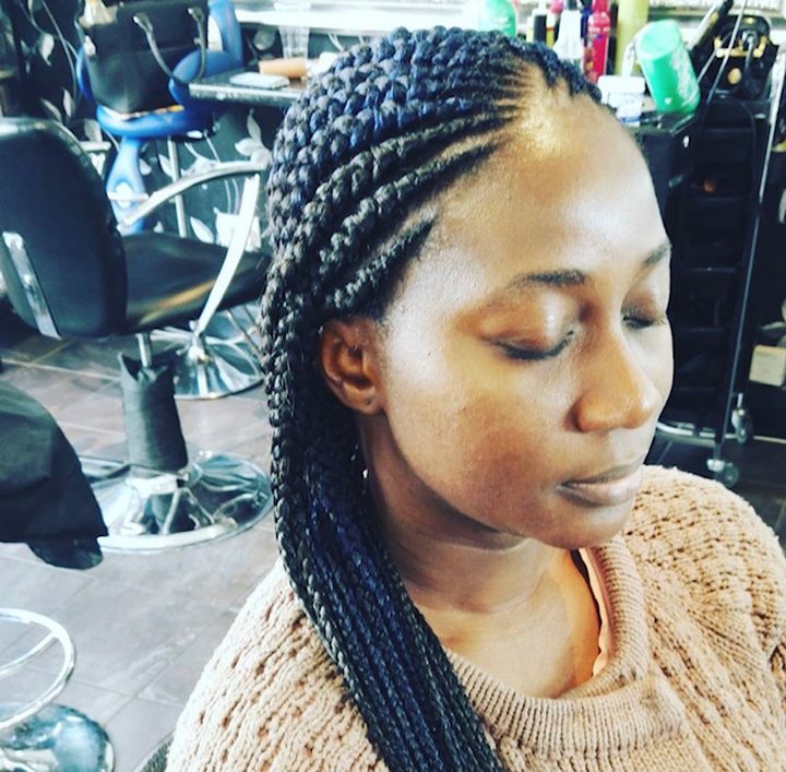 Long feed-in braids styled in a salon